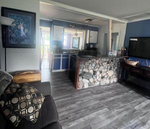a room with a living room and a kitchen with a television at The Dragonfly in Elk Rapids