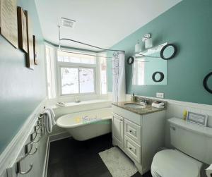 a bathroom with a sink and a tub and a toilet at All Points North in Beulah +27 photos