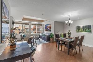 a living room with a table and a dining room at Luxury Rockies Retreat 1BR with Views in Canmore