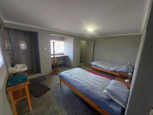 a small room with two beds and a sink at Wildwasser Farm stay in Hochfeld