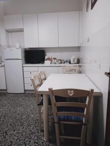 a kitchen with a table and chairs and a refrigerator at Meihome-Genova in Genova