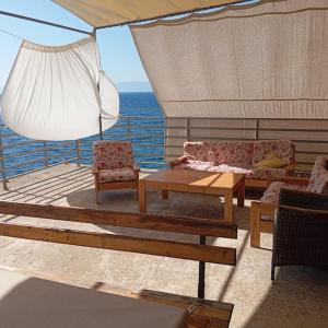 a deck of a boat with a table and chairs at Seaside house in wilderness in Zastražišće