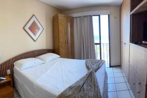 Ένα ή περισσότερα κρεβάτια σε δωμάτιο στο Flat Mobiliado na Beira Mar