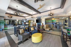 a lobby of a hotel with chairs and a bar at Best Western Plus Emerald Inn & Suites in Garden City
