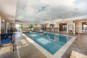 a large swimming pool in a hotel with a large ceiling at Best Western Plus Emerald Inn & Suites in Garden City