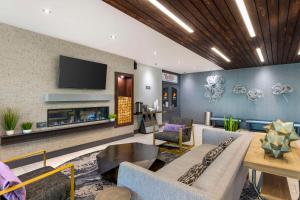 a living room with a couch and a tv at Aiden by Best Western South Reno in Reno