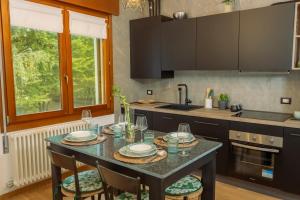 una cucina con un tavolo con sedie e un lavandino di Treviso City Center BnB - Comodo per Stazione e Centro Città a Treviso