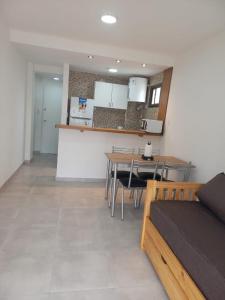 a living room with a table and a kitchen at Depto 41 in Santa Teresita