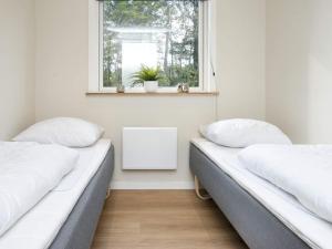 two beds in a room with a window at 8 person holiday home in Skjern-By Traum in Skjern