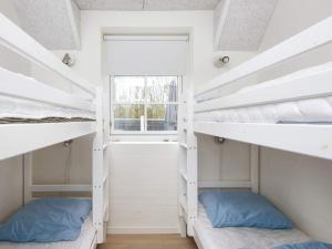 two bunk beds in a room with a window at Luxury Retreat with Pool in Ulfborg +65 photos