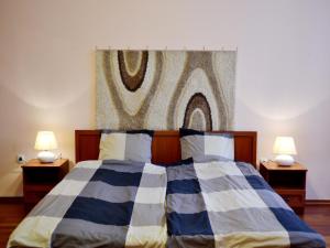 ブダペストにあるガブリエル アパートメントのベッドルーム1室(ベッド1台、テーブルにランプ2つ付)