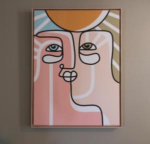 una pintura de una mujer en una pared en Charming Benson Home - Sleeps 5 Hot Tub!, en Omaha