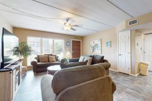 a living room with two couches and a tv at Beachview Condominiums #111 in South Padre Island