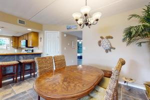 a dining room with a wooden table and chairs at Beachview Condominiums #111 in South Padre Island