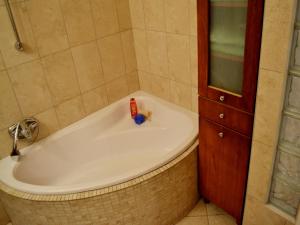 a bathroom with a bath tub with a toothbrush in it at Gabriel Apartment in Budapest