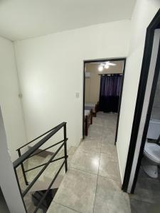a hallway with a bathroom with a toilet and a mirror at Duplex Monte Caseros in Monte Caseros +26 photos