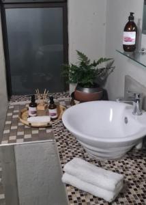 a bathroom with a tub and a sink with towels at La Dolce Vita in Hoedspruit