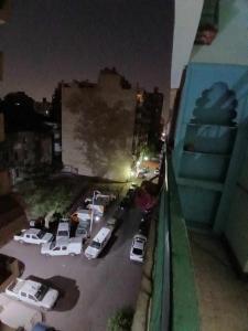 a group of cars parked in a parking lot at night at منيل روضه in Cairo +7 photos