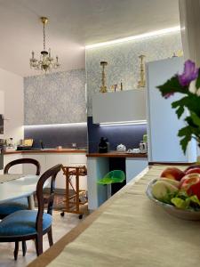 una cucina con tavolo e ciotola di frutta di Villa Salina - Vicina al mare con giardino privato a Trabia