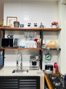 a kitchen with a sink and a counter top at Cabanas Cantareira - Araucária in Mairiporã