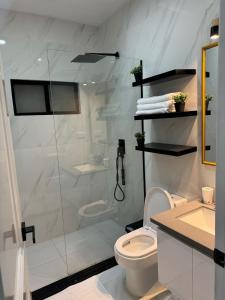 a white bathroom with a shower and a toilet at M&J apartment in Cuenca +13 photos