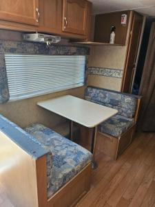 a table and two chairs in an rv at Comanche Teepee at Nomad Landing in Clayton