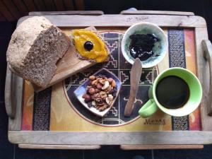 a tray with a plate of bread and a cup of coffee at Cabañas SurEnya in El Bolsón