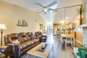 a living room with a couch and a table at Waterfront Lazy Days Condo with Views and Pool Access! in Osage Beach