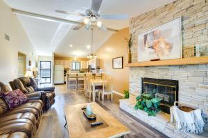 a living room with a couch and a fireplace at Waterfront Lazy Days Condo with Views and Pool Access! in Osage Beach