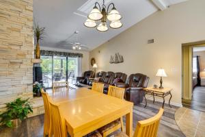 a dining room and living room with a table and chairs at Waterfront Lazy Days Condo with Views and Pool Access! in Osage Beach