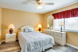 a bedroom with a bed and a ceiling fan at Waterfront Lazy Days Condo with Views and Pool Access! in Osage Beach