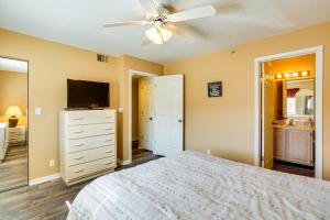 a bedroom with a bed and a ceiling fan at Waterfront Lazy Days Condo with Views and Pool Access! in Osage Beach