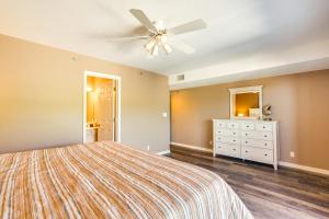 a bedroom with a bed and a ceiling fan at Waterfront Lazy Days Condo with Views and Pool Access! in Osage Beach