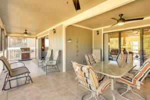 a dining room with a table and chairs at Waterfront Lazy Days Condo with Views and Pool Access! in Osage Beach