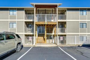 a building with a car parked in a parking lot at Waterfront Lazy Days Condo with Views and Pool Access! in Osage Beach