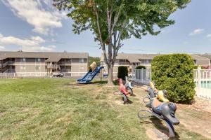 a park with a playground with a slide at Waterfront Lazy Days Condo with Views and Pool Access! in Osage Beach