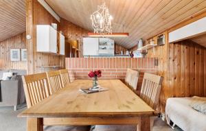a dining room with a wooden table and chairs at Pet Friendly Home In Thisted With Sauna in Thisted