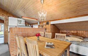 a kitchen and dining room with a wooden table and chairs at Pet Friendly Home In Thisted With Sauna in Thisted