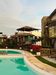 a resort with a swimming pool and a building at Chale Praia Barrinha in Barrinha