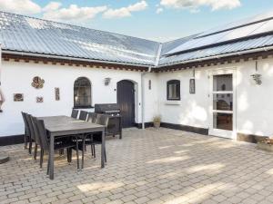a patio with a table and a grill at Charming Farmhouse Retreat - By Traum Ferienwohnungen in Frederikshavn