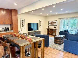 a living room with a table and a tv at Saugerties Waterfront Getaway in Saugerties +101 photos