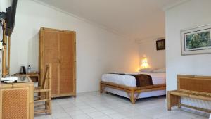 ein Schlafzimmer mit einem Bett und einer Kommode in der Unterkunft Keyani Bungalows Lovina in Lovina + 37 Fotos