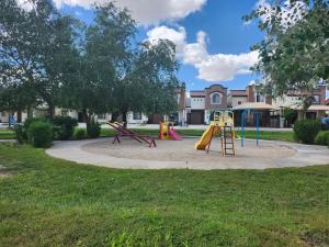 a playground with a slide in a park at Casa a 5 min., del Consulado americano in Ciudad Juárez