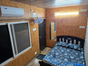 a small room with a bed and a window at Barla's Home Stay - Mini Studio Room in Shamshabad