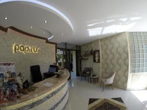 a lobby of a puphuana store with a counter and chairs at Papirus Hotel in Adrasan