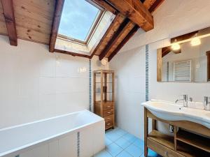 a bathroom with a tub and a sink and a window at Chalet Savage 170m² près des pistes, Wi-Fi, parking, matériel bébé - FR-1-267-299 in Villarembert +12 photos