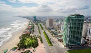 an aerial view of a beach and a tall building at Premium Apartment, Balcony Ocean View,Infinity Pool, 01 Min To My Khe Beach, PickUp Managed by Ala Carte Da Nang in Da Nang