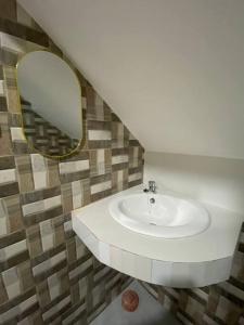 a bathroom with a sink and a mirror at RHM homestay in Naga +16 photos