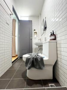 a white bathroom with a sink and a toilet at Monday Guesthouse Hatyai in Hat Yai