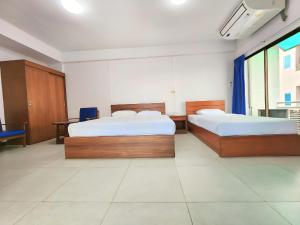 Postel nebo postele na pokoji v ubytování Siam Palace Hotel
